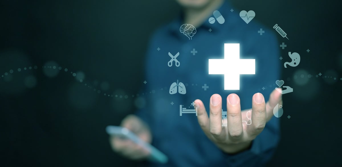 A person using a smartphone with a health cross symbol, representing easy healthcare payment options