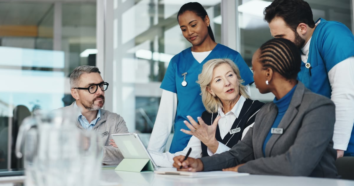 Healthcare professionals reviewing plans together in an office