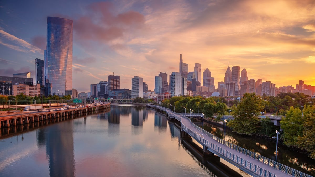 The Philadelphia skyline at sunrise reflecting across the Schuylkill River