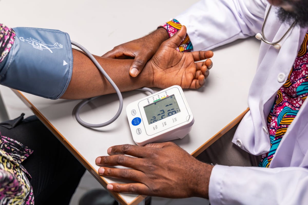 A healthcare professional measuring a patient's blood pressure during a wellness screening